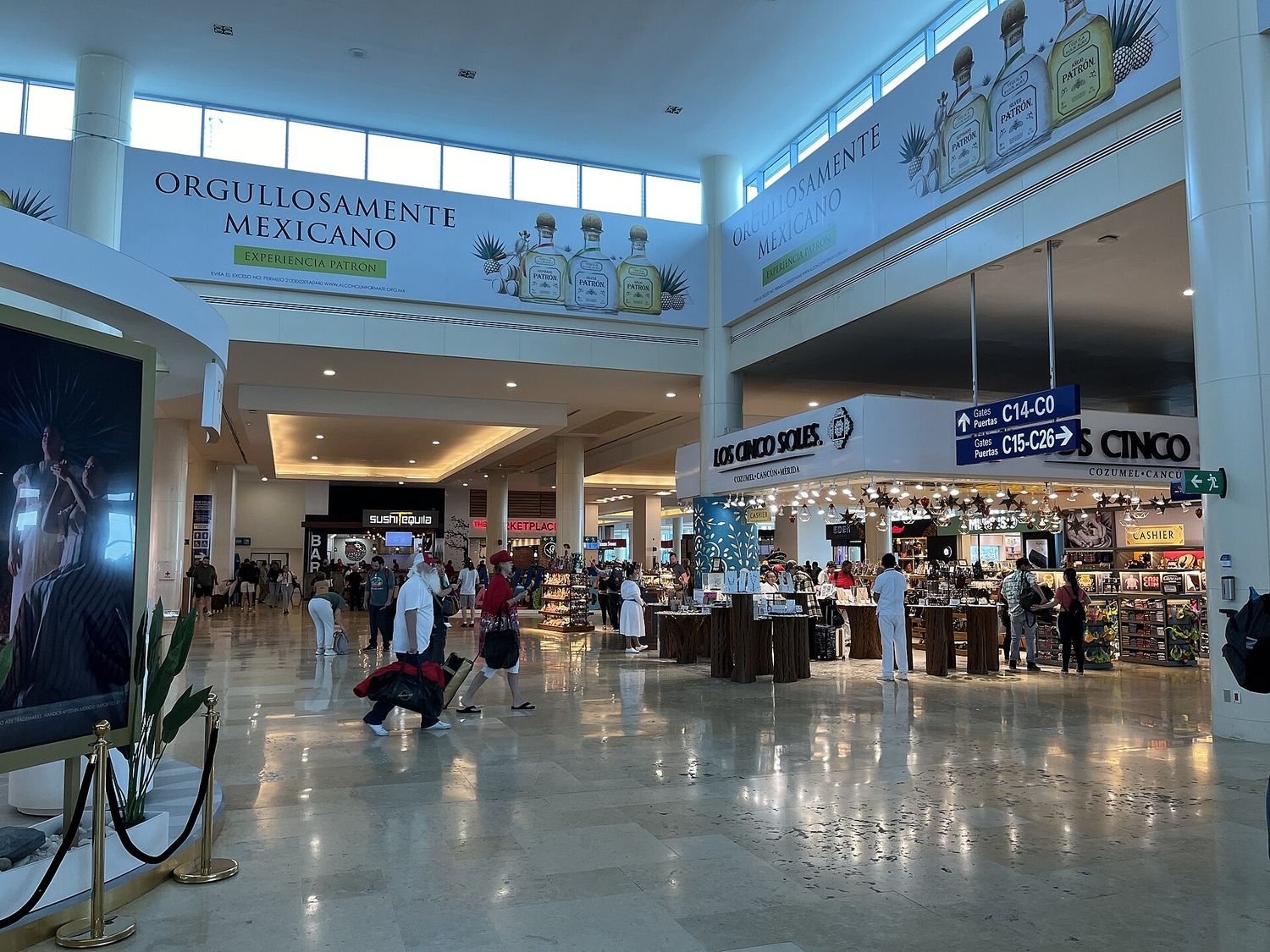 Cancun International Airport concourse with passengers and shops
